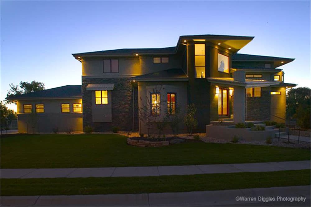 Modern house plan exterior with stone accents, cantilevered rooflines, and multiple gables.