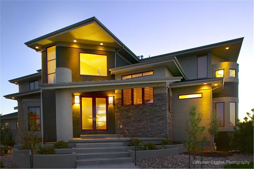 House plan exterior with modern design. Two-story home with flat roof, recessed entry, and stone facade. Featuring large windows and unique angles.